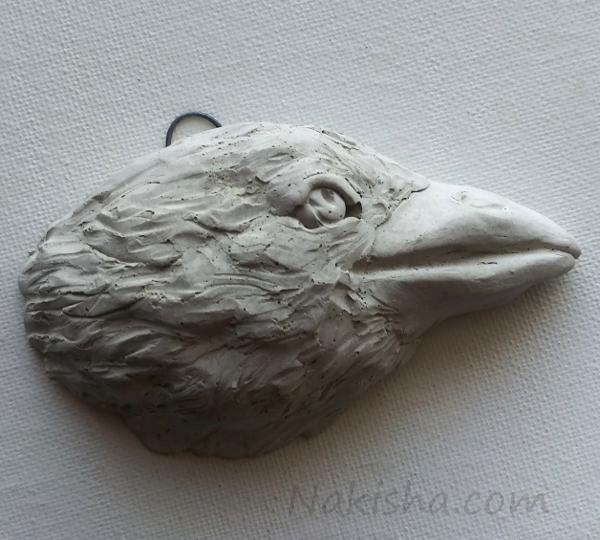 Concrete raven head wall Sculpture by Nakisha